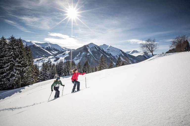Zwei Personen genießen den Winter beim Schneewandern in den Kitzbüheler Alpen.